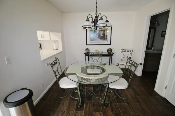 a view of a dining room with furniture a chandelier and wooden floor