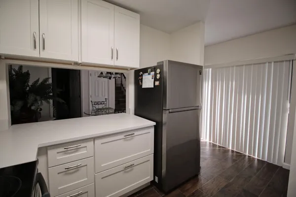 a kitchen with refrigerator and cabinets