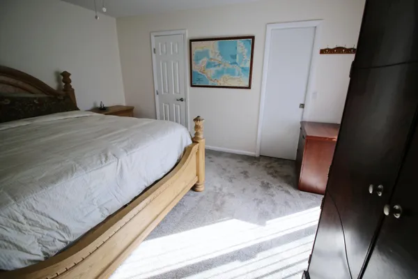 a bedroom with a bed and a rug