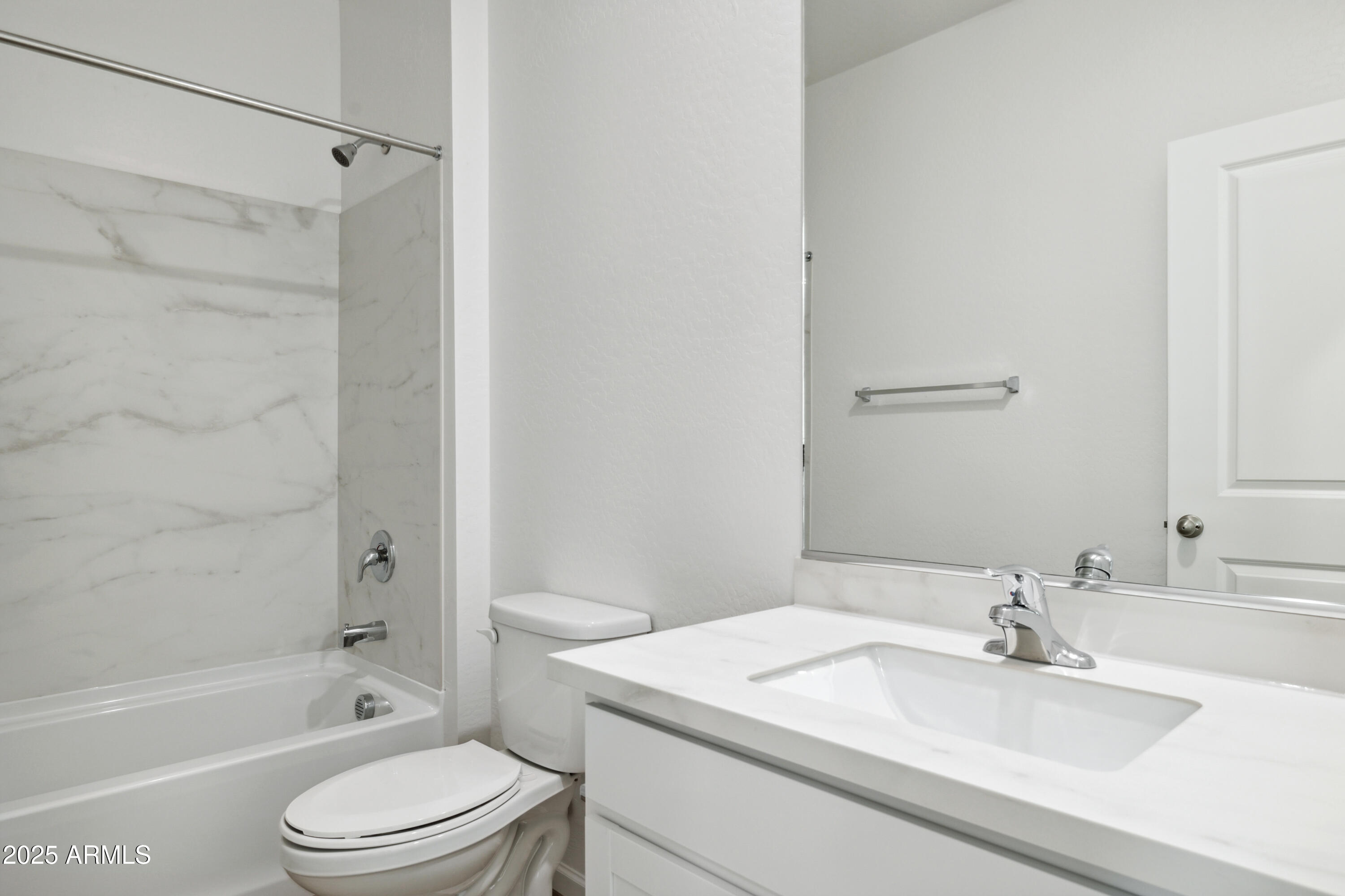25470 West Fraktur Road Buckeye, AZ 85326 - Photo 6 of 12 a bathroom with a sink a toilet and a bathtub