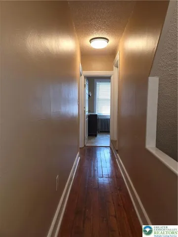 a view of hallway with wooden floor