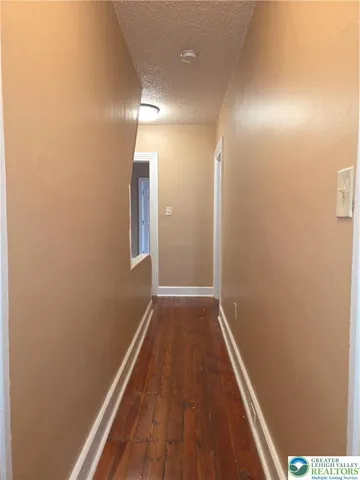 a view of hallway with wooden floor