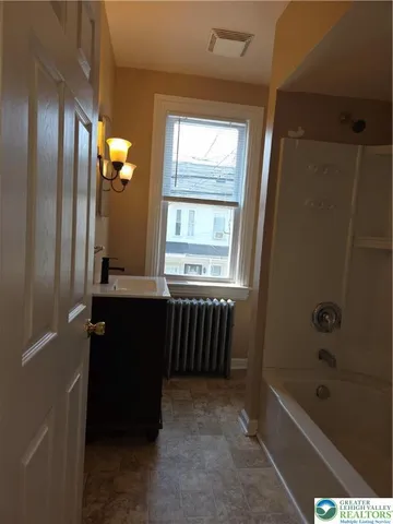 a bathroom with a bathtub and a shower