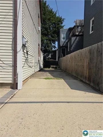 a view of a brick house with a small yard