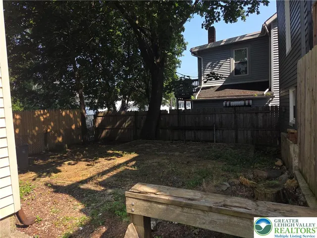 a backyard of a house with outdoor seating