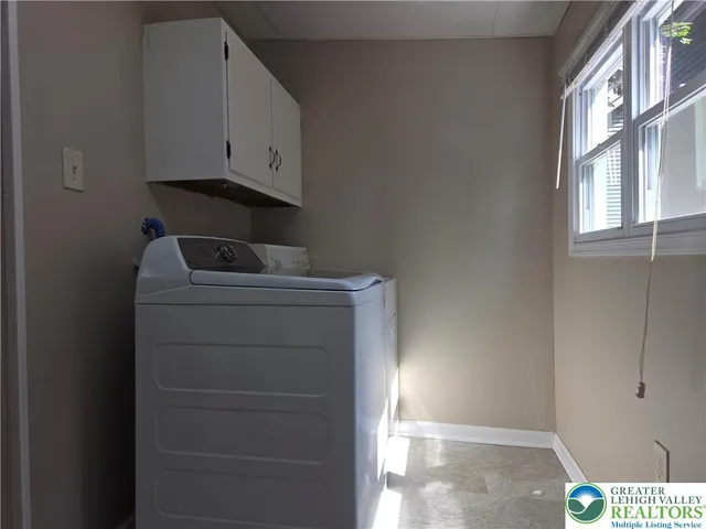 a utility room with closet dryer and washer