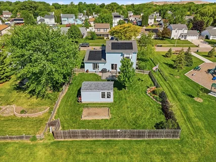 an aerial view of residential houses with outdoor space and river