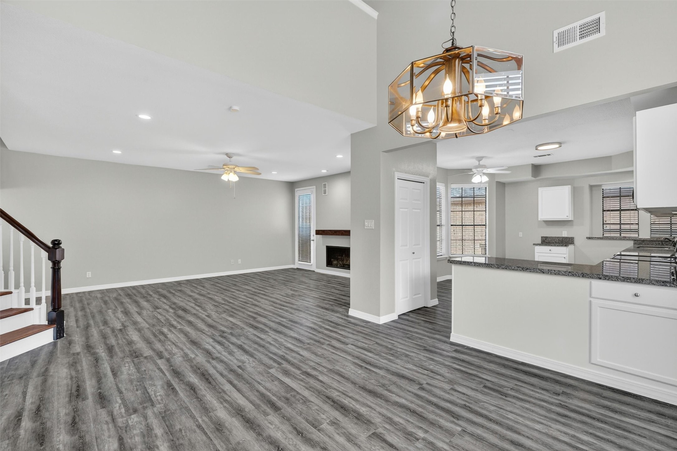 12929 Kingsbridge Lane Houston, TX 77077 - Photo 11 of 42 This beautifully updated open-concept home offers the spacious layout and modern finishes today’s buyers are searching for. Featuring soaring ceilings, luxury-style flooring, designer lighting, and an oversized living area, this home is perfect for entertaining and everyday comfort. The seamless flow between the living room, dining area, and kitchen creates a bright and inviting atmosphere filled with natural light. Buyers will love the contemporary kitchen with abundant counter space, sleek cabinetry, and