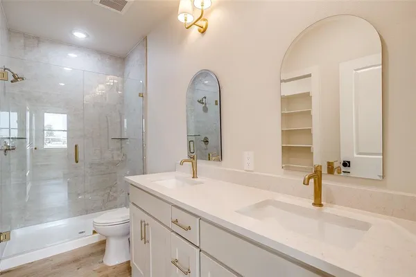 a kitchen with white cabinets stainless steel appliances and window