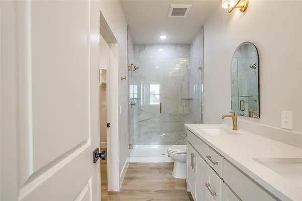 a view of kitchen with kitchen island wooden floor center island and stainless steel appliances