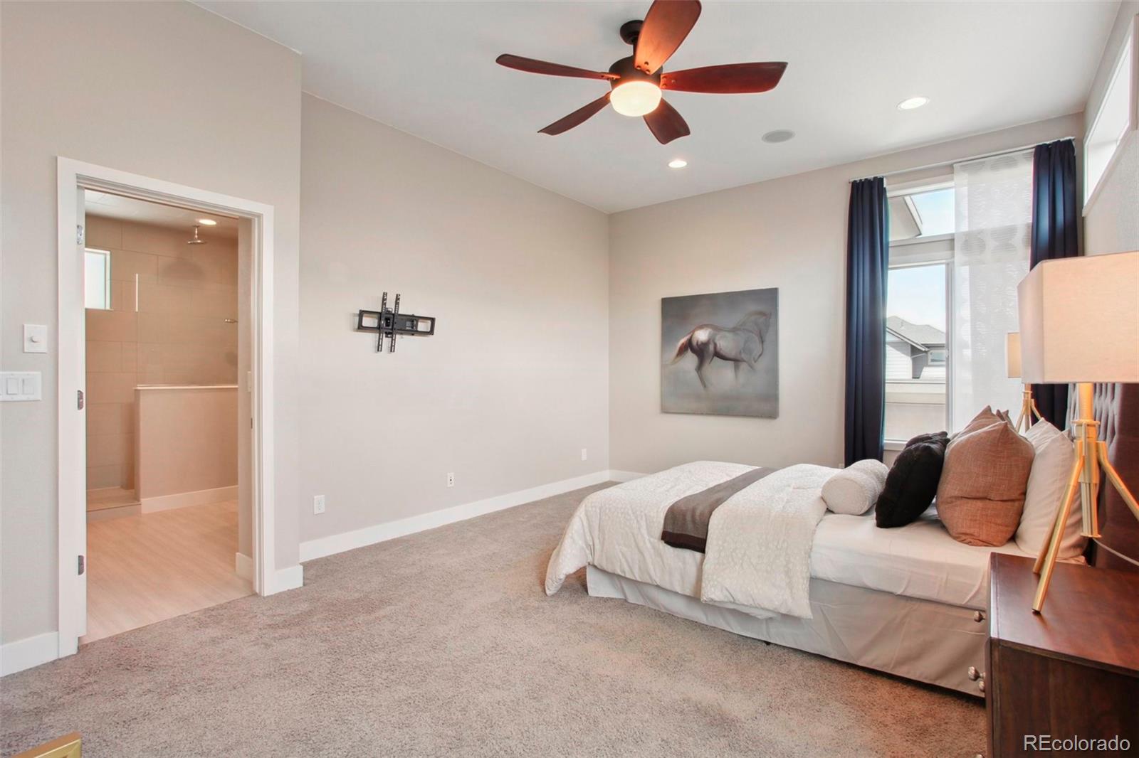 6735 Avrum Drive Denver, CO 80221 - Photo 14 of 29 a bedroom with a bed and a chandelier