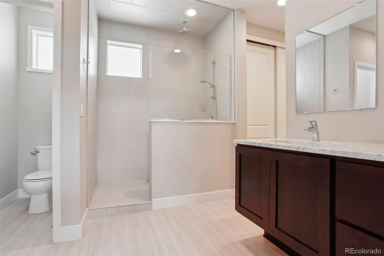 6735 Avrum Drive Denver, CO 80221 - Photo 16 of 29 a bathroom with a sink and a mirror