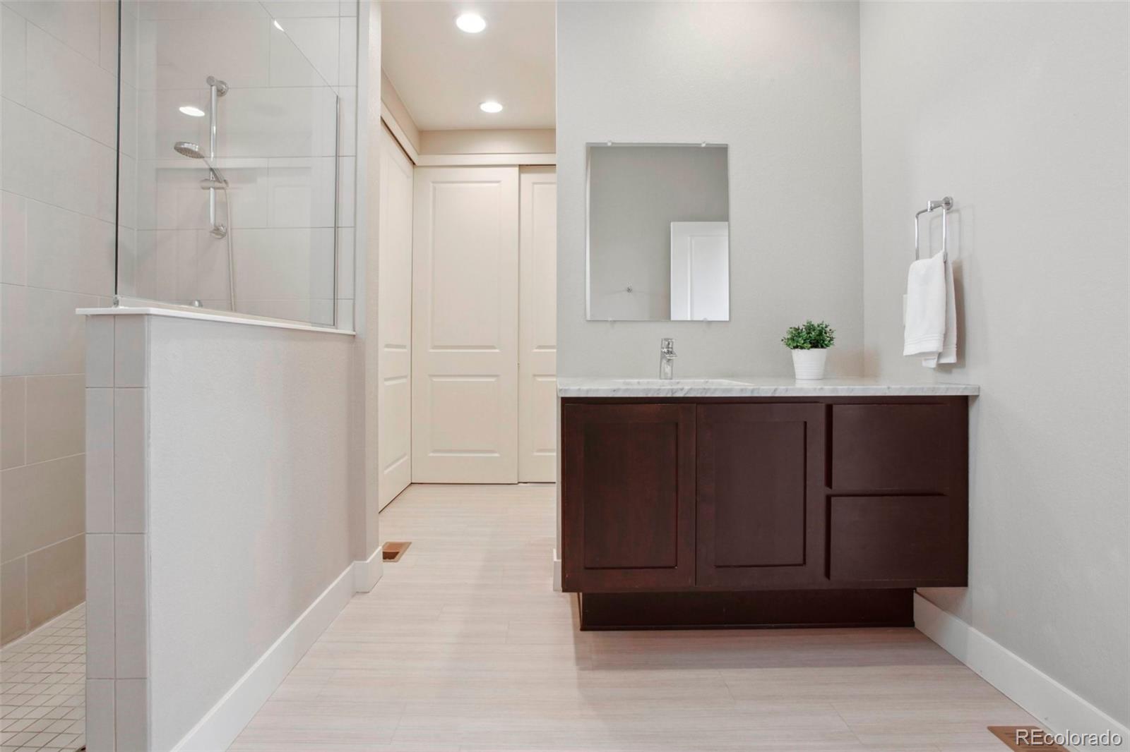 6735 Avrum Drive Denver, CO 80221 - Photo 17 of 29 a bathroom with a sink and a mirror