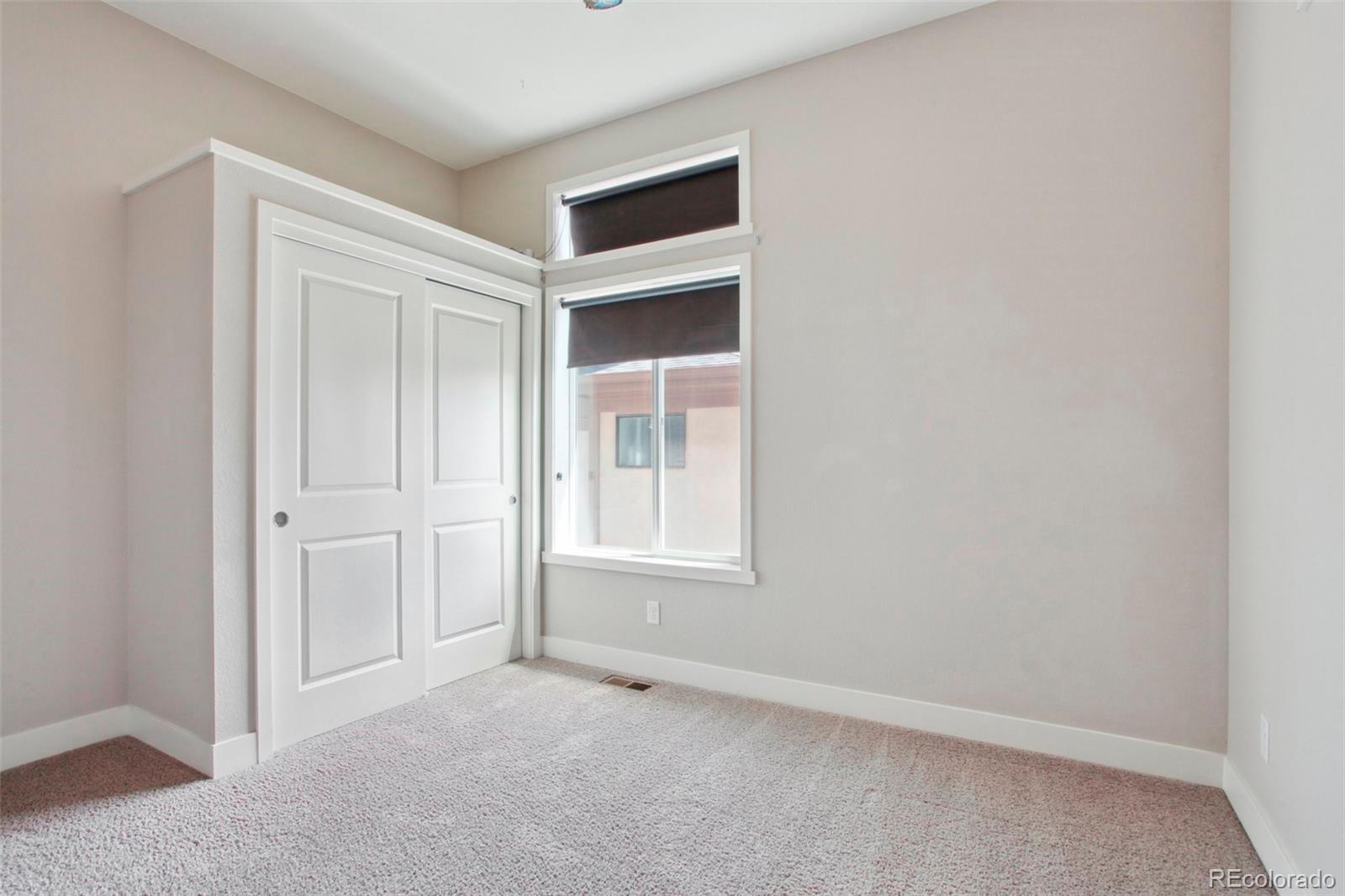 6735 Avrum Drive Denver, CO 80221 - Photo 19 of 29 an empty room with windows