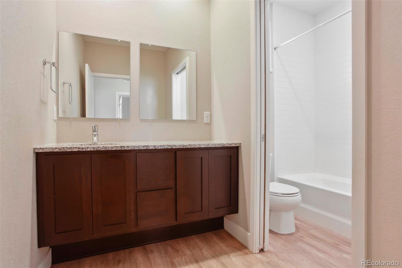6735 Avrum Drive Denver, CO 80221 - Photo 20 of 29 a bathroom with a granite countertop sink toilet and shower