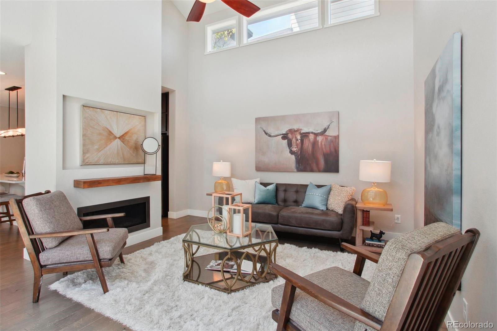 6735 Avrum Drive Denver, CO 80221 - Photo 2 of 29 a living room with furniture and a fireplace