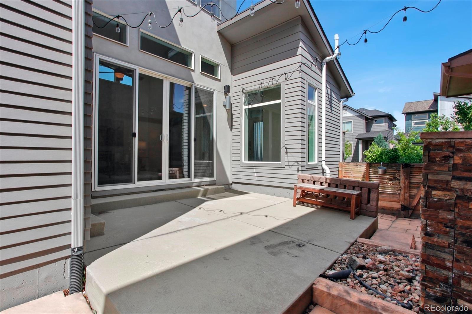 6735 Avrum Drive Denver, CO 80221 - Photo 27 of 29 a backyard of a house with outdoor seating