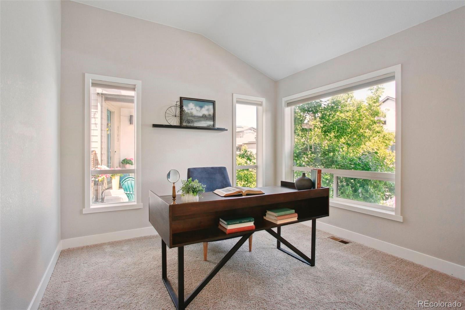 6735 Avrum Drive Denver, CO 80221 - Photo 10 of 29 a dining room with furniture and a window