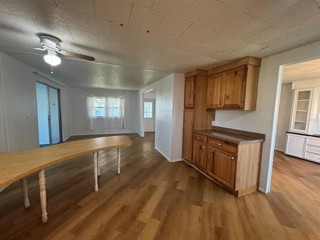 a kitchen with wooden floors and natural light