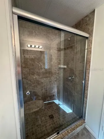 a bathroom with a glass shower door