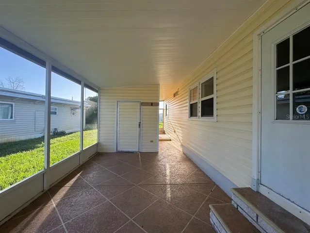 a view of a hallway with an outdoor space