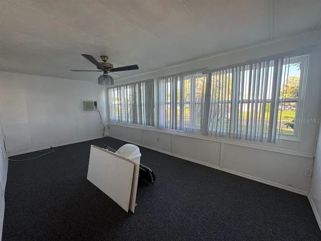 a room with wooden floor and windows