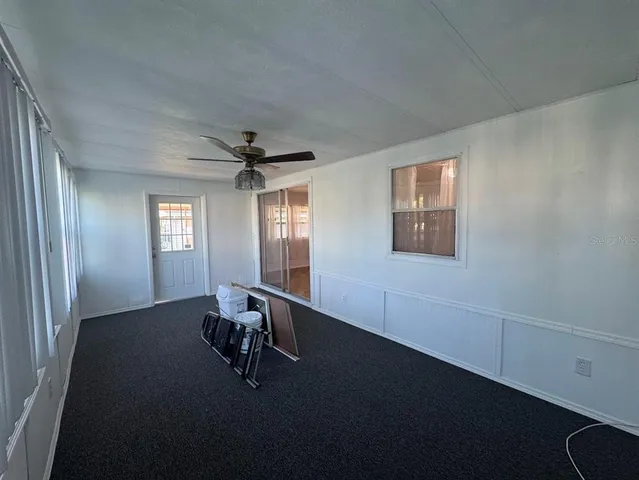 a view of a livingroom with furniture and a window
