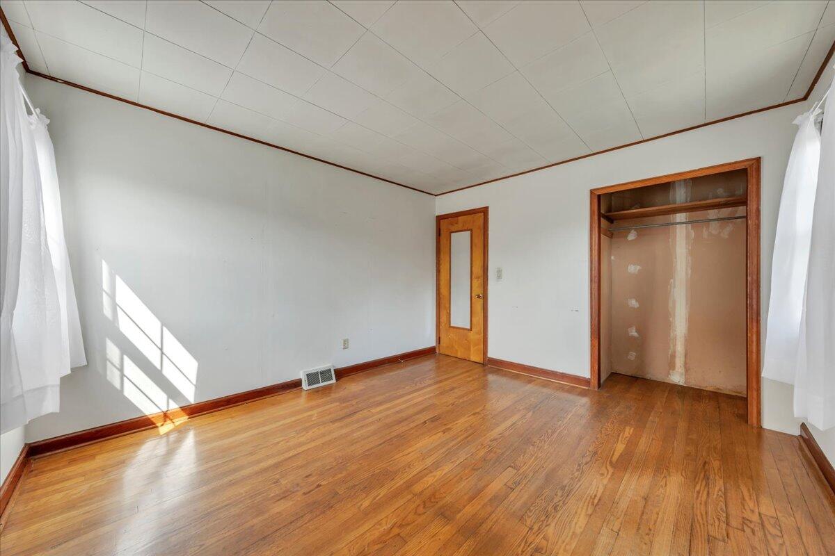 201 Long Avenue Covington, VA 24426 - Photo 15 of 43 an empty room with wooden floor and closet