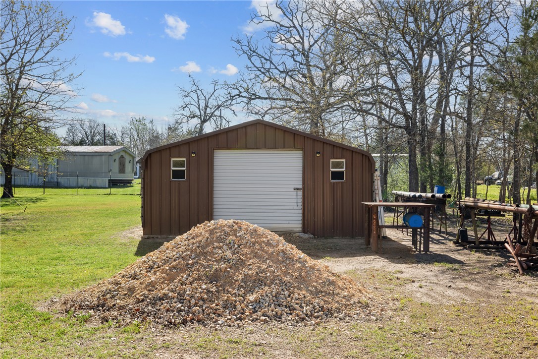 302 Dan Drive Somerville, TX 77879 - Photo 13 of 20 a backyard of a house with barbeque oven and outdoor seating