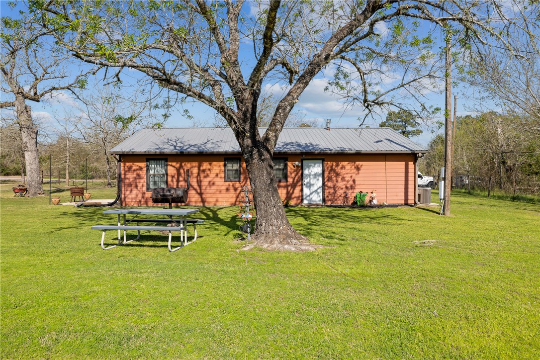 302 Dan Drive Somerville, TX 77879 - Photo 18 of 20 a backyard of a house with table and chairs
