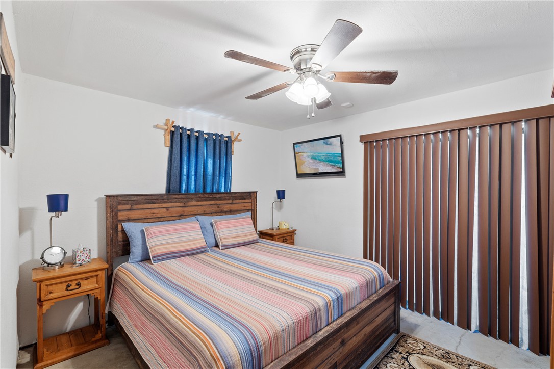 302 Dan Drive Somerville, TX 77879 - Photo 8 of 20 a bedroom with a large bed and a chandelier