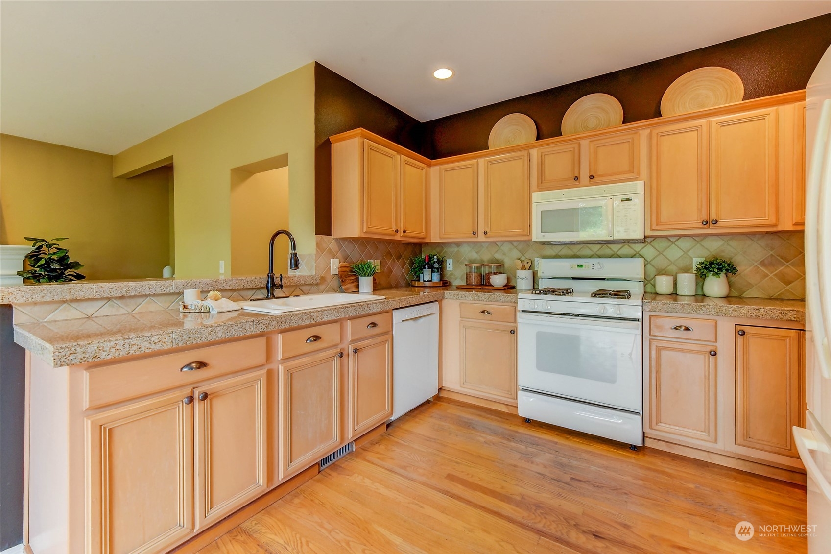 18290 Tahoma Street Southeast Monroe, WA 98272 - Photo 11 of 32 a kitchen with stainless steel appliances granite countertop a sink cabinets and wooden floor