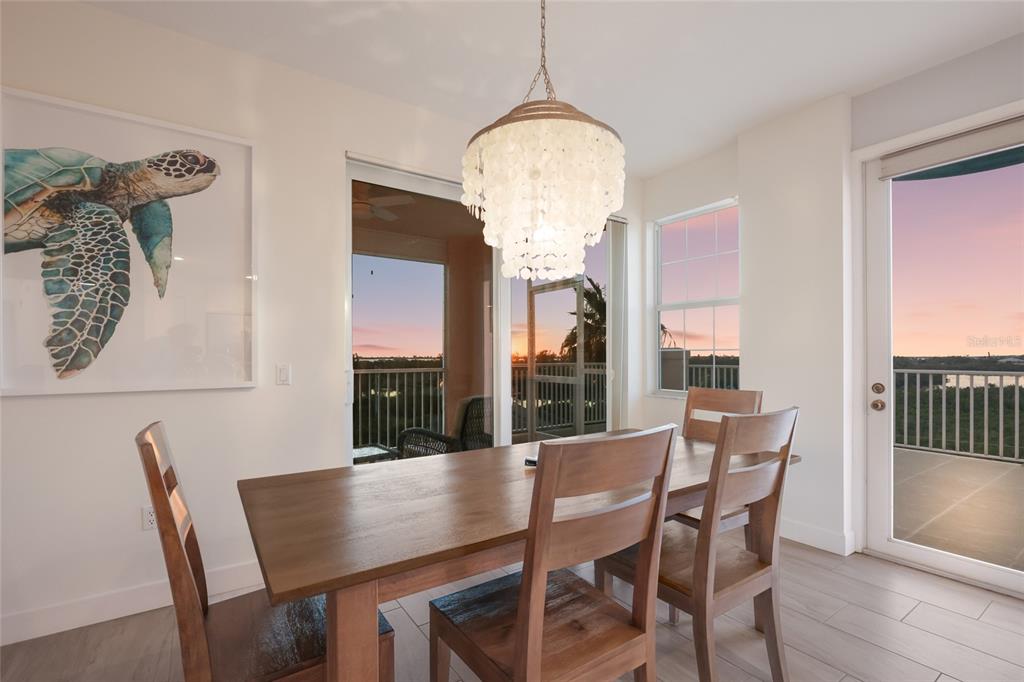 13113 Gasparilla Road, Unit 503 Placida, FL 33946 - Photo 12 of 87 a view of a dining room with furniture and wooden floor