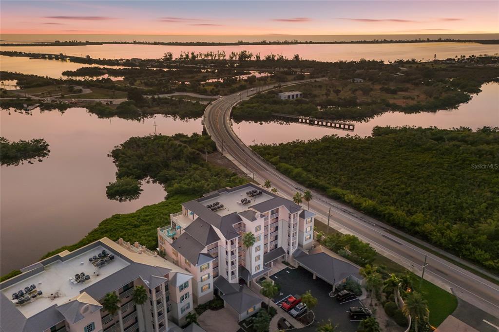 13113 Gasparilla Road, Unit 503 Placida, FL 33946 - Photo 37 of 87 a view of a lake with a yard and mountain view