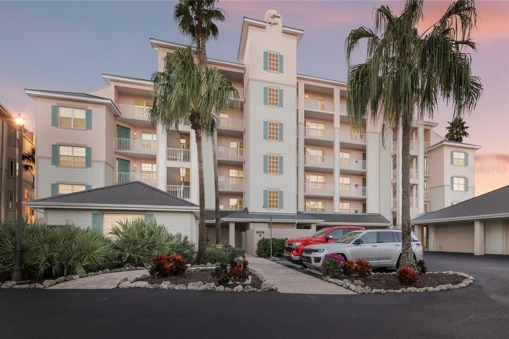 13113 Gasparilla Road, Unit 503 Placida, FL 33946 - Photo 4 of 87 a front view of a building with plants and palm trees