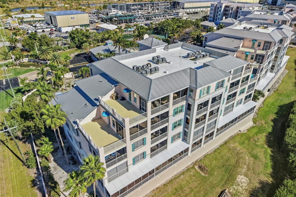 13113 Gasparilla Road, Unit 503 Placida, FL 33946 - Photo 47 of 87 a aerial view of a multi story residential apartment building with a yard