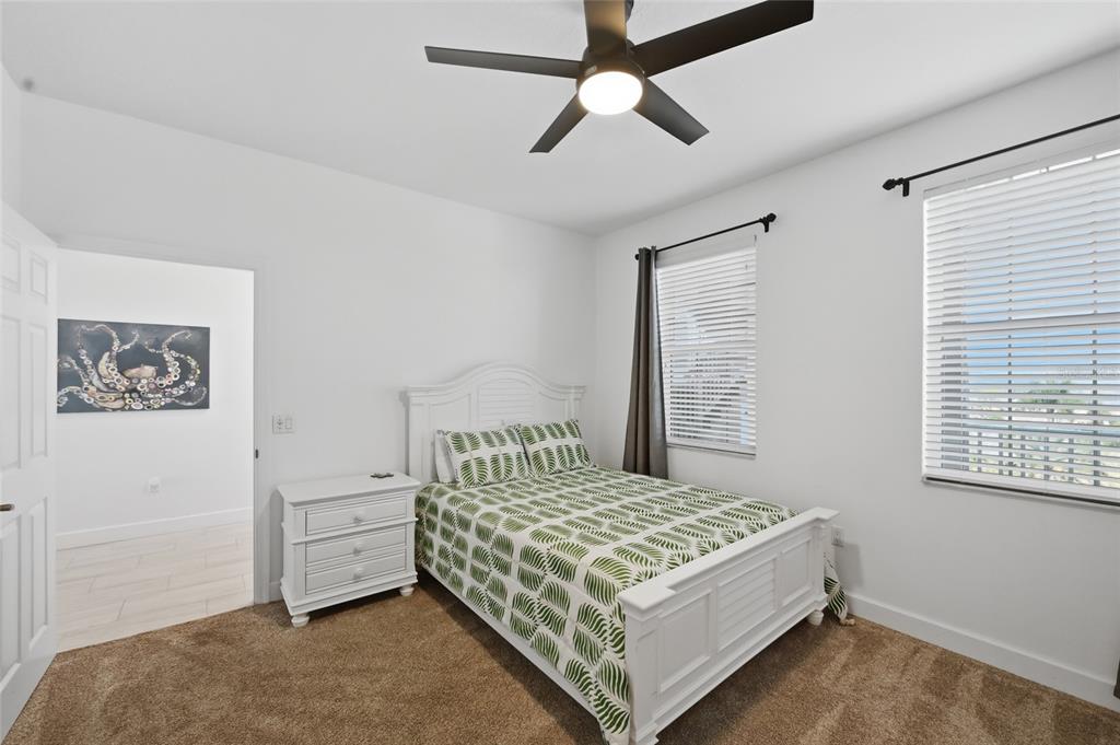 13113 Gasparilla Road, Unit 503 Placida, FL 33946 - Photo 57 of 87 a bedroom with a bed and a ceiling fan