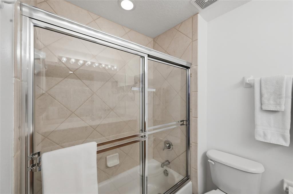 13113 Gasparilla Road, Unit 503 Placida, FL 33946 - Photo 59 of 87 a bathroom with a granite countertop a toilet and a shower