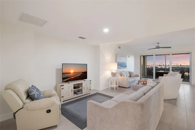 a living room with furniture and kitchen view