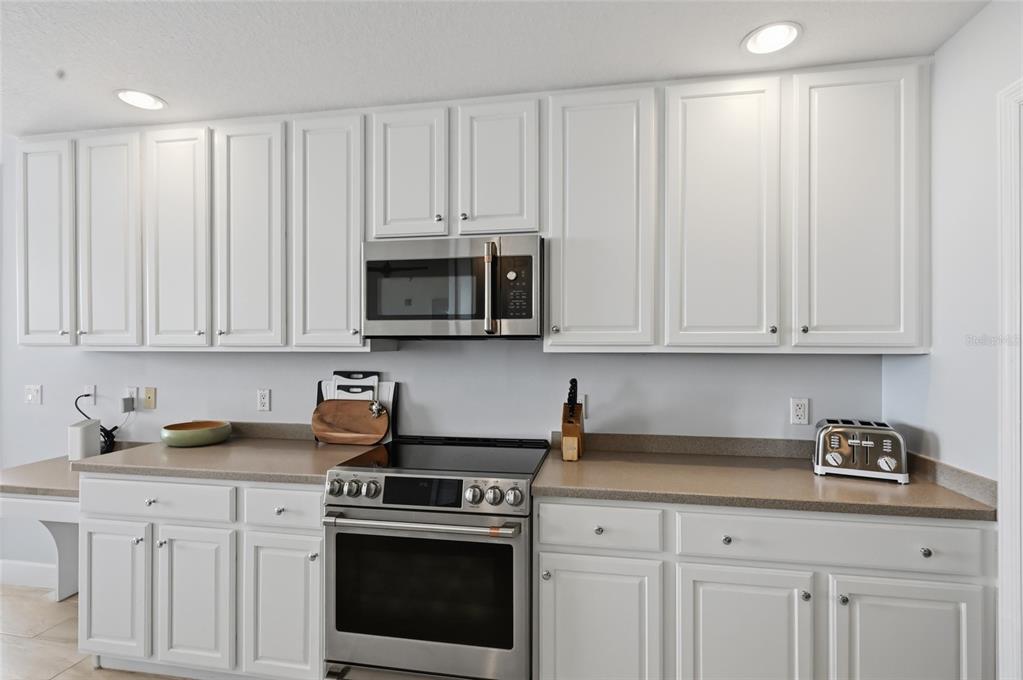 13113 Gasparilla Road, Unit 503 Placida, FL 33946 - Photo 71 of 87 a kitchen with white cabinets and white appliances