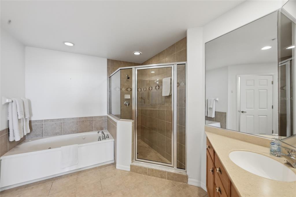 13113 Gasparilla Road, Unit 503 Placida, FL 33946 - Photo 78 of 87 a bathroom with a tub shower sink and mirror
