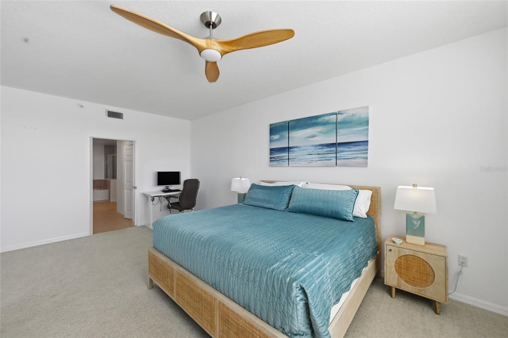 13113 Gasparilla Road, Unit 503 Placida, FL 33946 - Photo 81 of 87 a bedroom with a bed a couch and a flat tv screen on the dresser