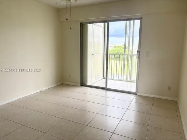 a view of a livingroom with an empty space and a window