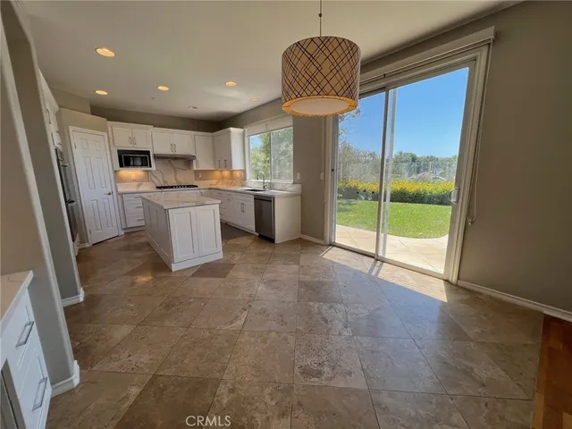 a view of a livingroom with wooden floor and a fireplace