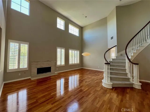 a kitchen that has a lot of white cabinets and stainless steel appliances