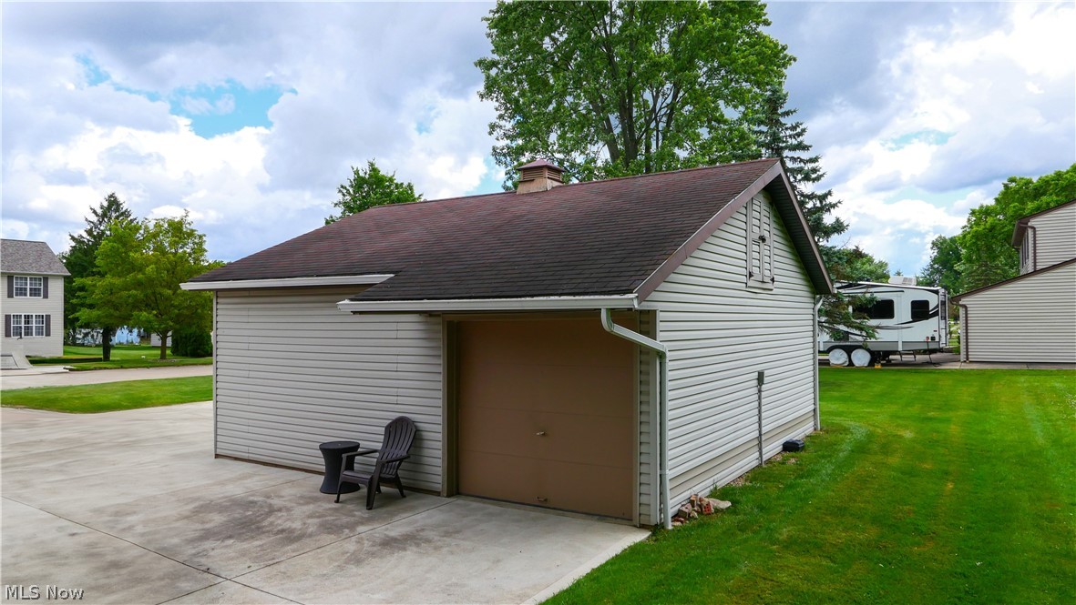 11247 Prospect Road Strongsville, OH 44149 - Photo 7 of 49 View of outdoor structure with a garage and a lawn