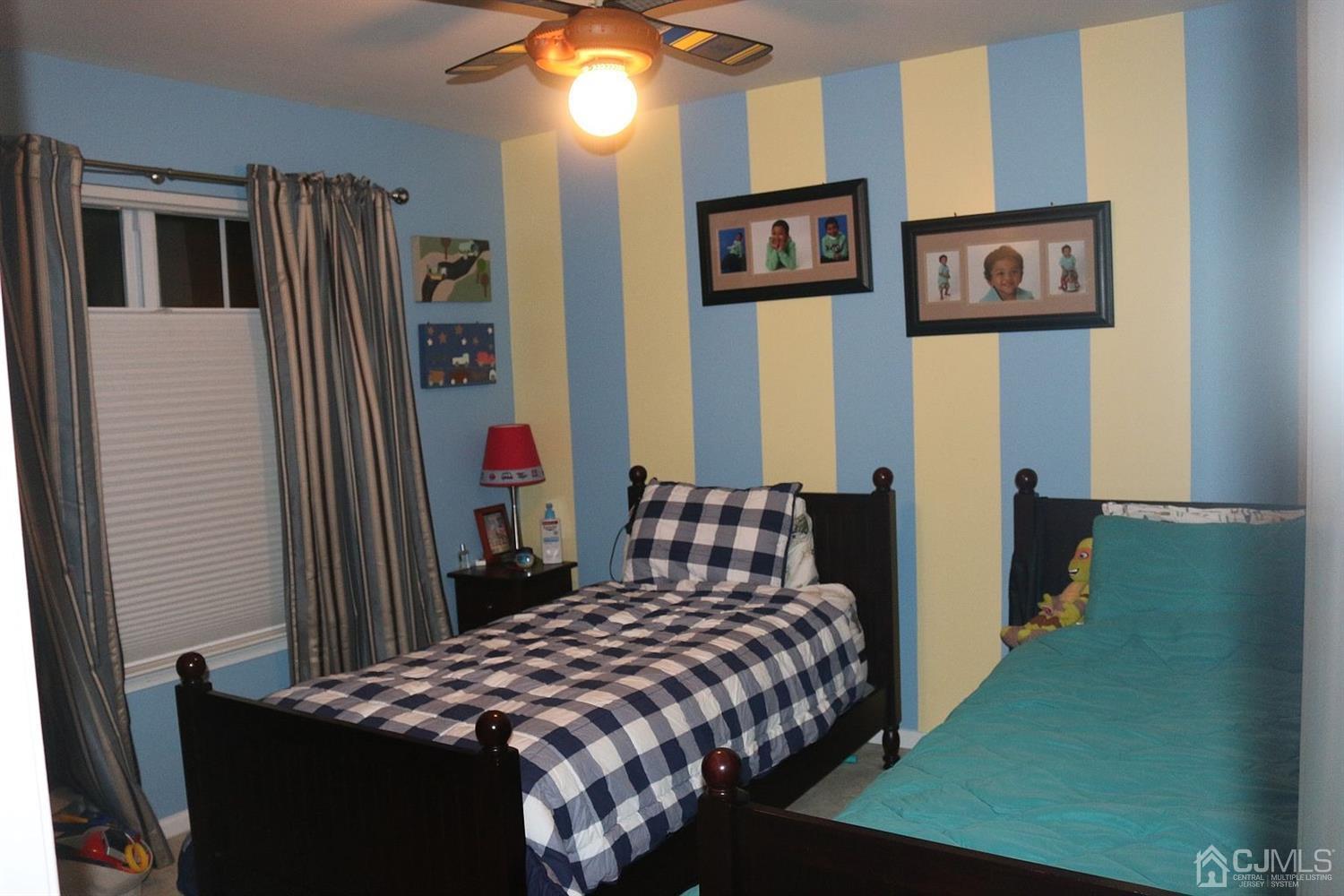 354 Hawthorne Road North Brunswick, NJ 08902 - Photo 4 of 9 a bedroom with a bed and a chandelier
