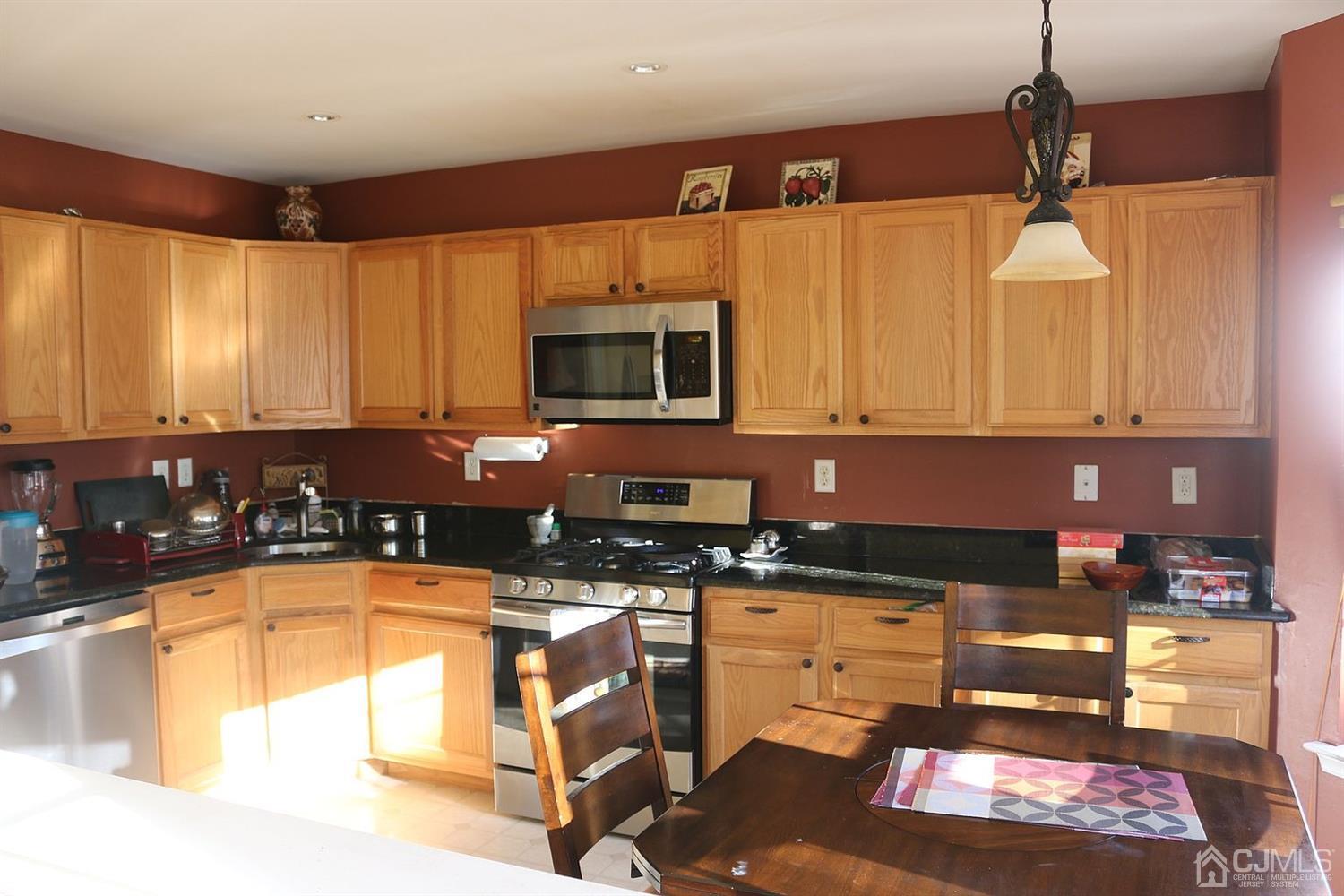 354 Hawthorne Road North Brunswick, NJ 08902 - Photo 6 of 9 a kitchen with granite countertop a stove a sink and a microwave