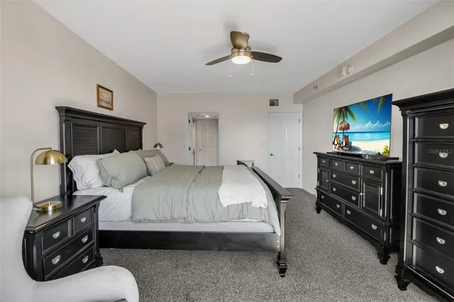 a bedroom with a bed and a tv on the dresser
