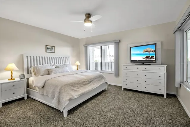 a bedroom with a bed a window and dresser